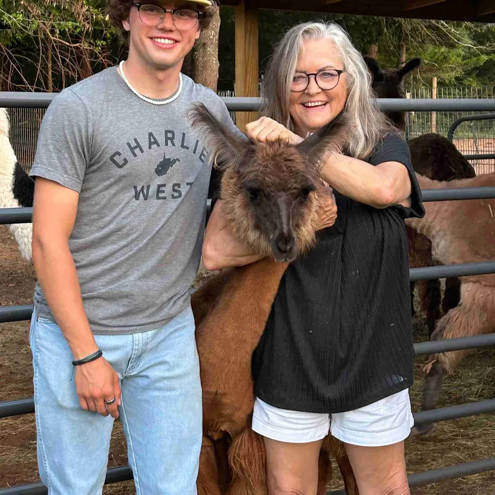 Reggi Durch and family with a llama at the farm